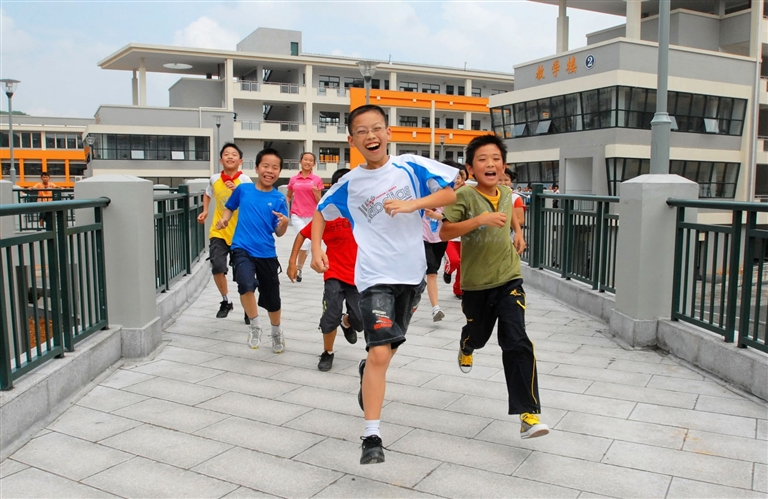 图为初一年级的同学们在新学校里快乐地奔跑着.记者陈欣摄